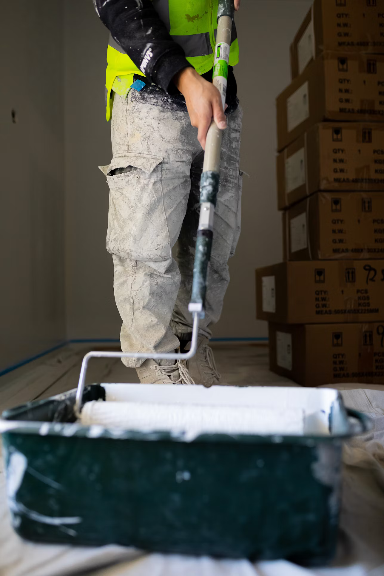 The owner rolling out a fresh coat of paint on a job site in Española