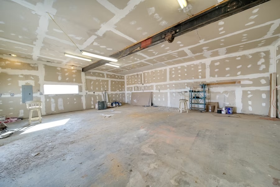 A wide interior taped out in fresh drywall, ready for finishing